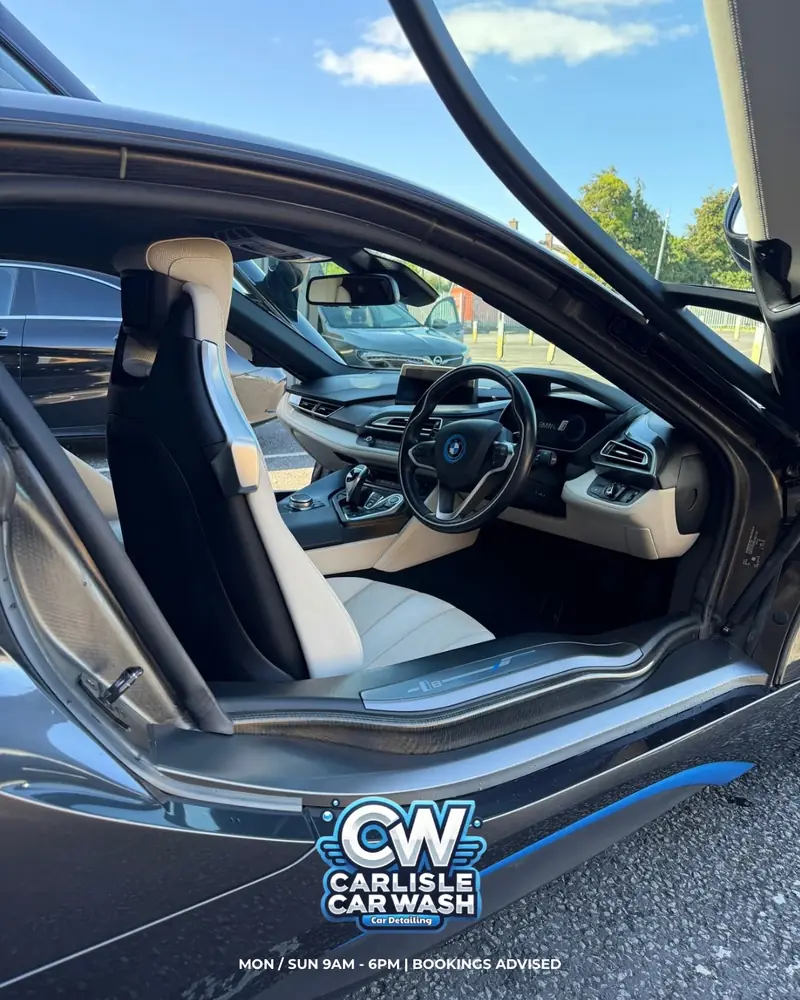 Detailed cream and black BMW i8 interior with the door open